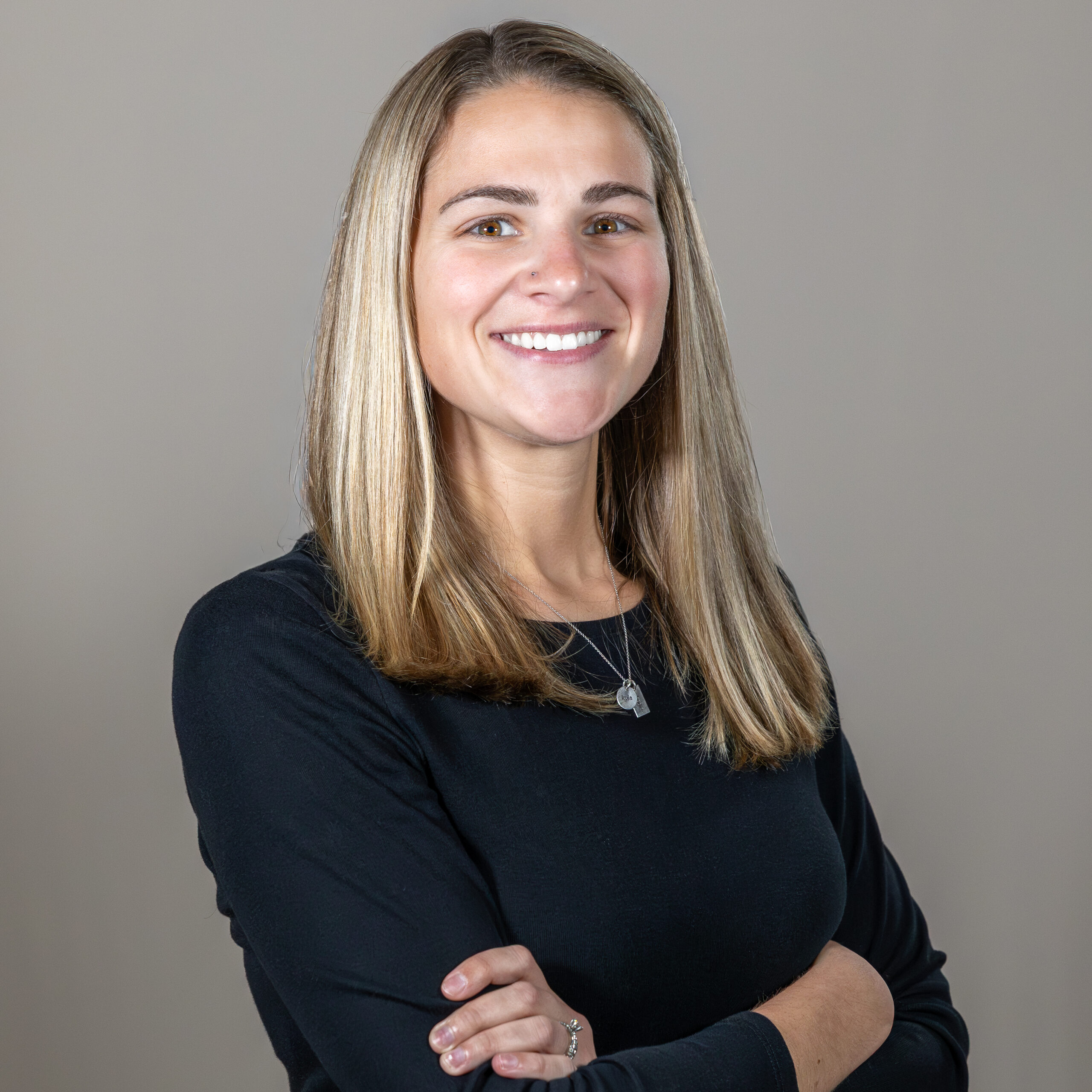 Portrait of the Director of Sales standing confidently in a professional setting, representing lifestyle homes and guiding clients who build a new house or getting a house built.